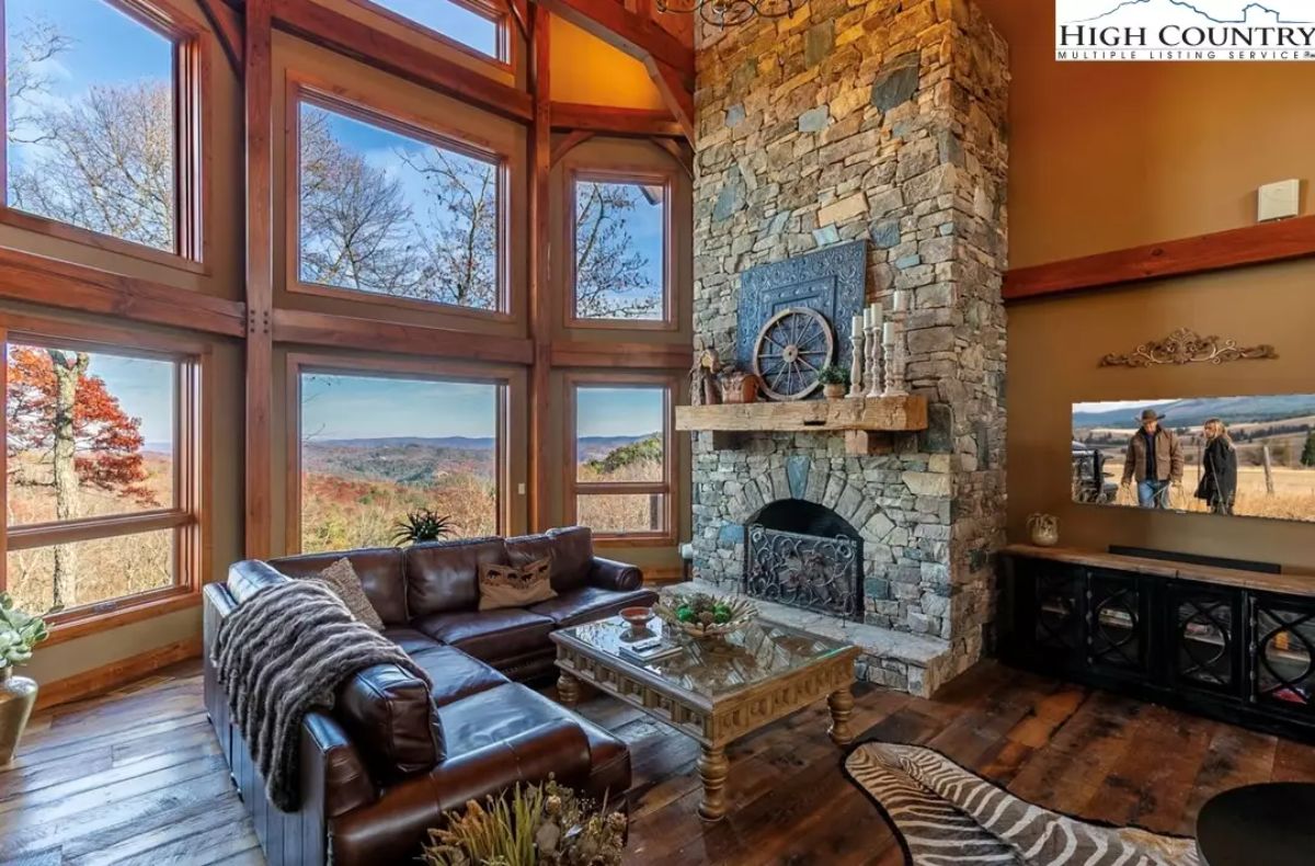 Two-story windows frame expansive mountain views and flood the room with natural light.