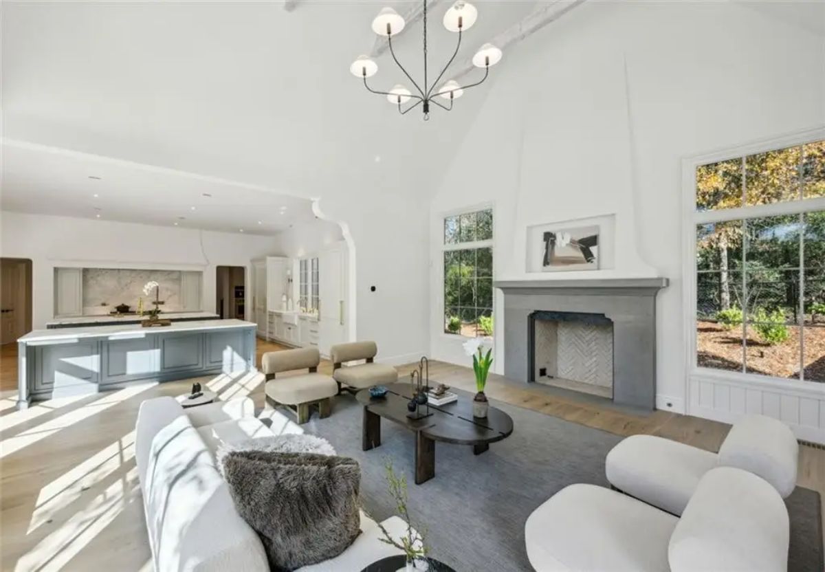 Spacious, airy living room featuring cathedral ceilings and a minimalist aesthetic. 