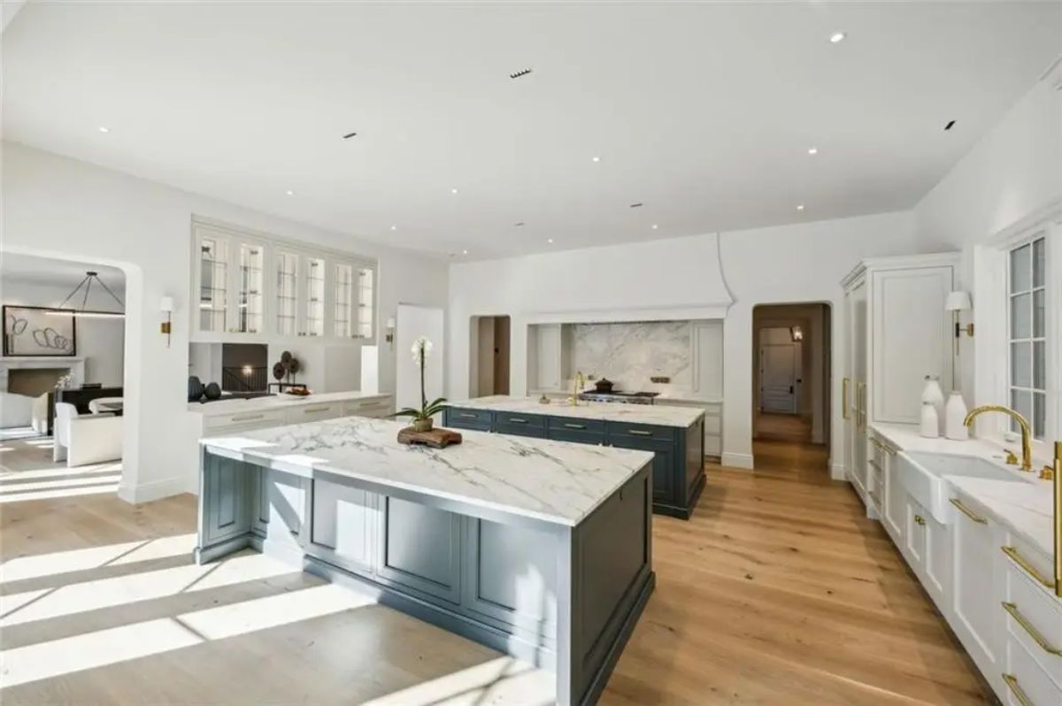 Dual marble-topped islands anchor this sleek, luxurious kitchen. 