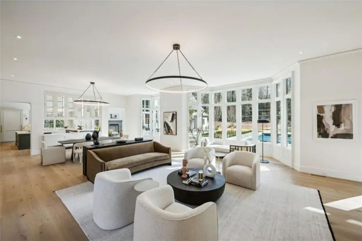 Expansive great room wrapped in windows, drenched in natural light with contemporary finishes. 