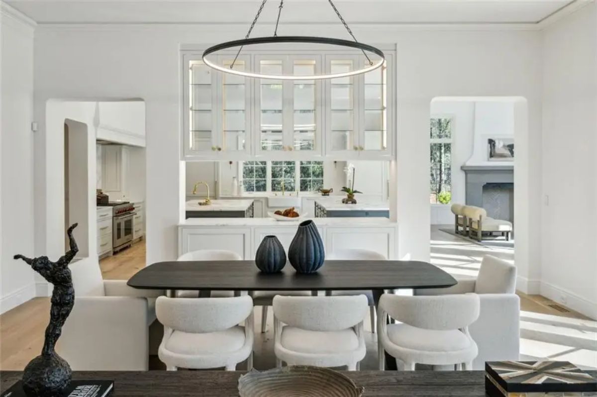 Elegant dining space accented by modern lighting and refined contrast tones. 