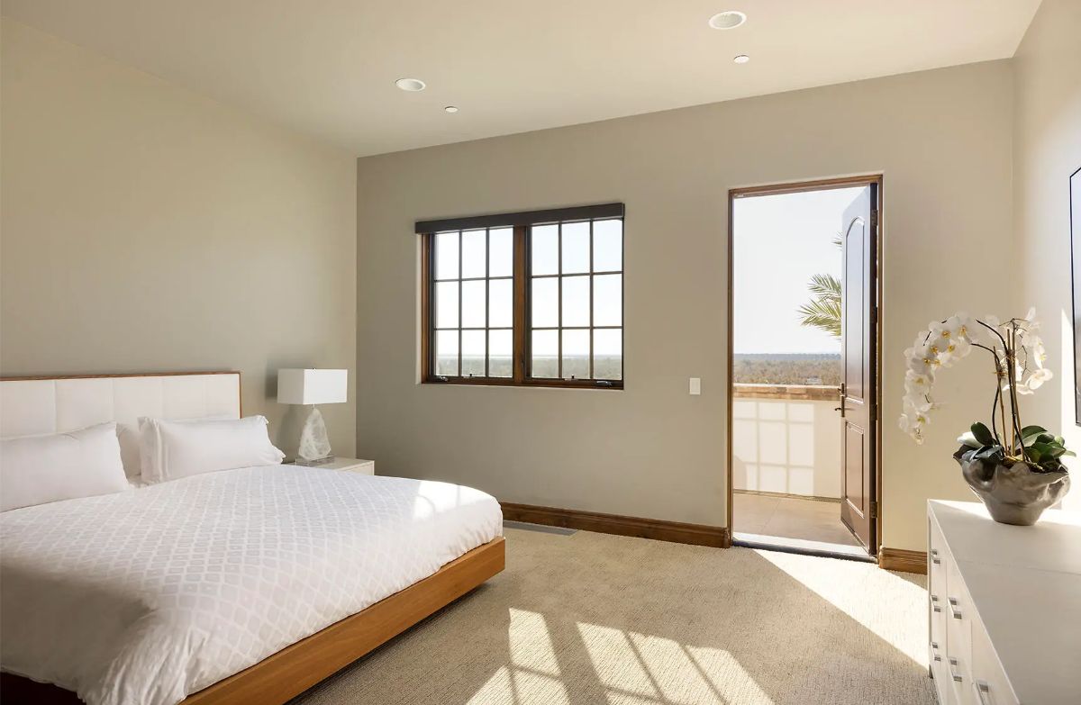 Natural light enters through large windows and a glass door leading to a private outdoor space.