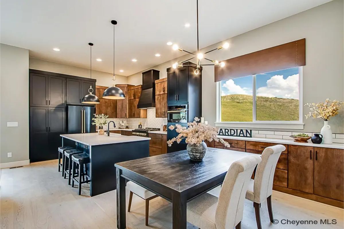 Two-toned cabinetry combines dark upper cabinets with warm wood lower cabinets.