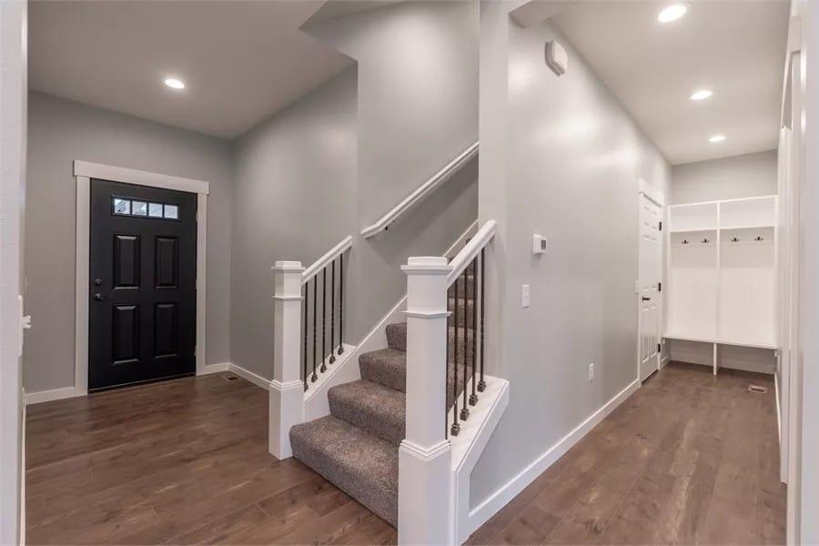 Notice the Contrast of the Sleek Black Door Against Neutral Walls