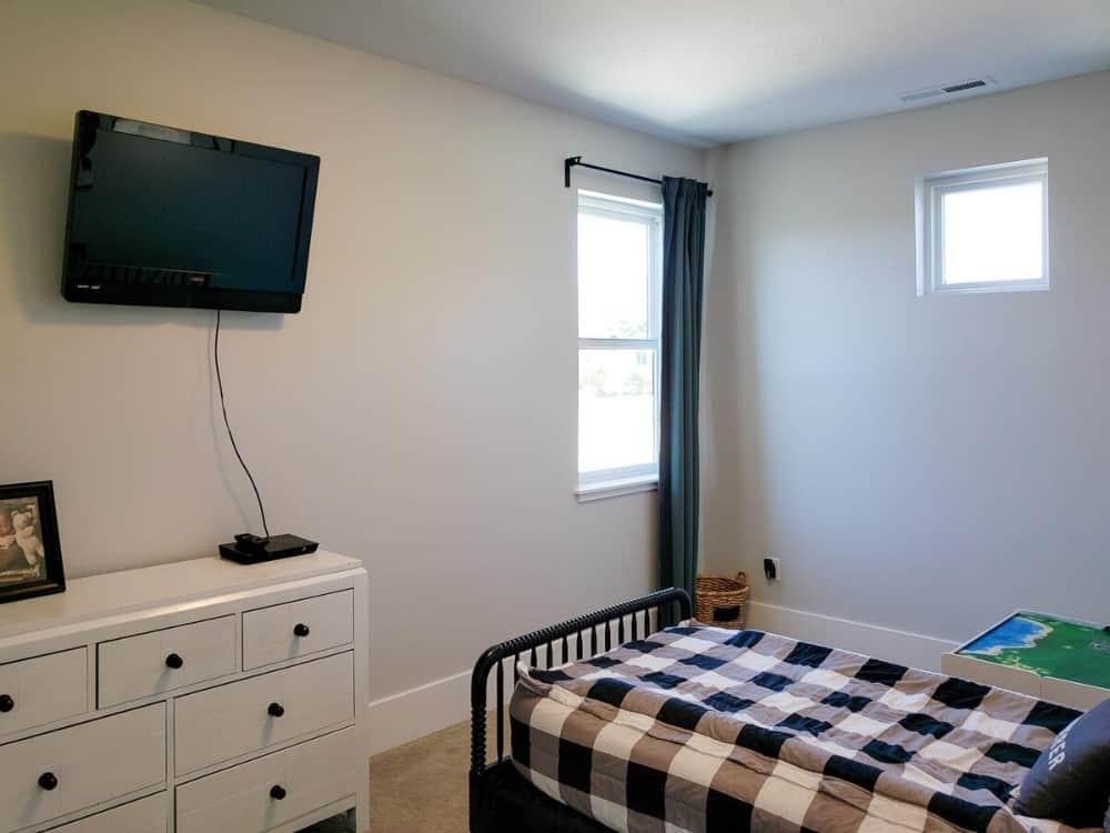 Cozy Bedroom with Simple Decor and Wall-Mounted Television