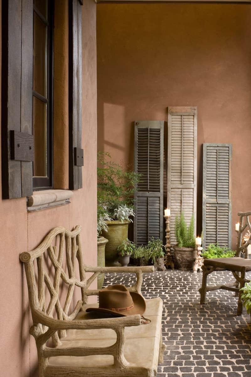 Rustic Courtyard with Old World Shutters and Cobblestone Charm