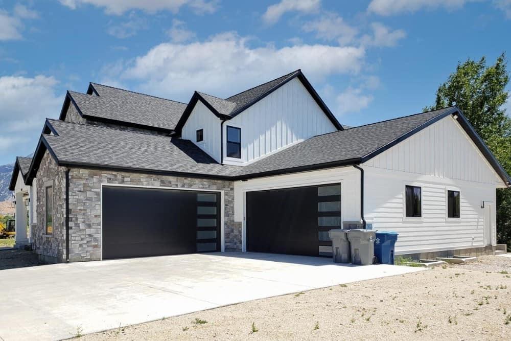 Check Out the Black Garage Doors Against the Stone Facade