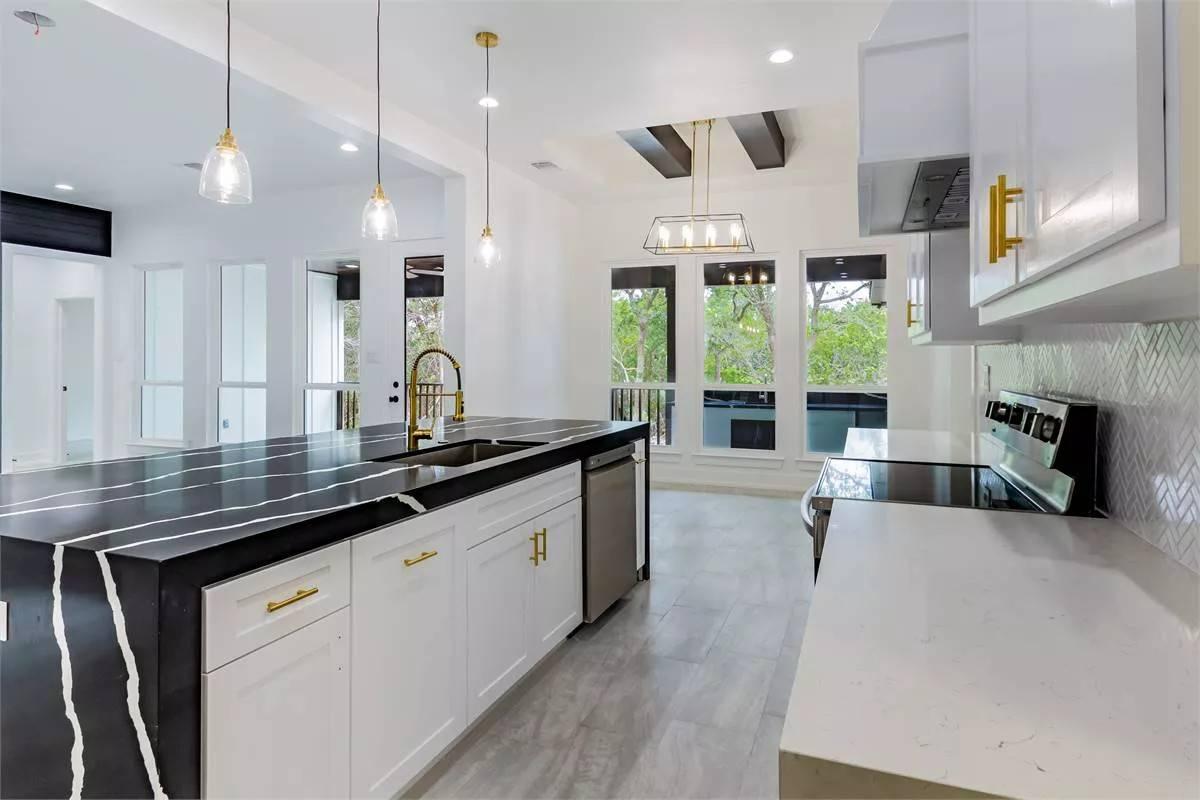 Notice the Elegant Contrast of Dark Granite and White Cabinets