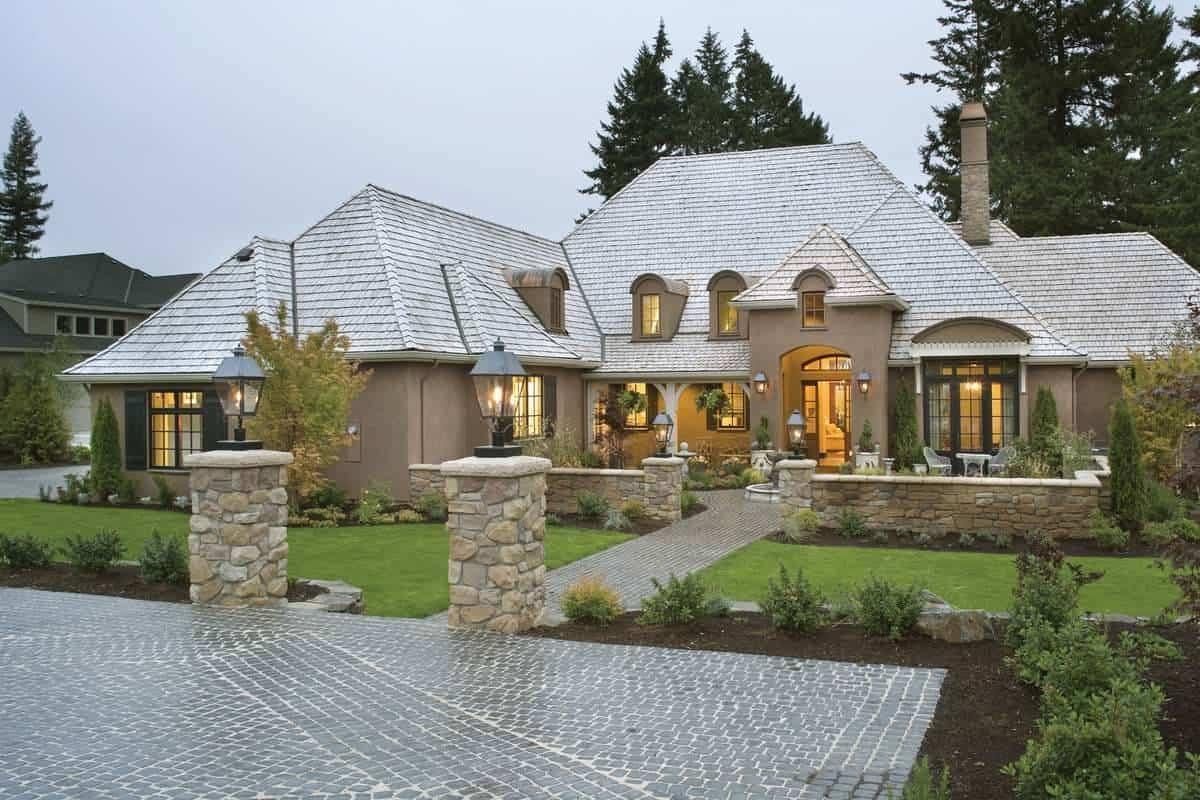 Chateau-Style Elegance with Stone Pillars and Cobblestone Pathway