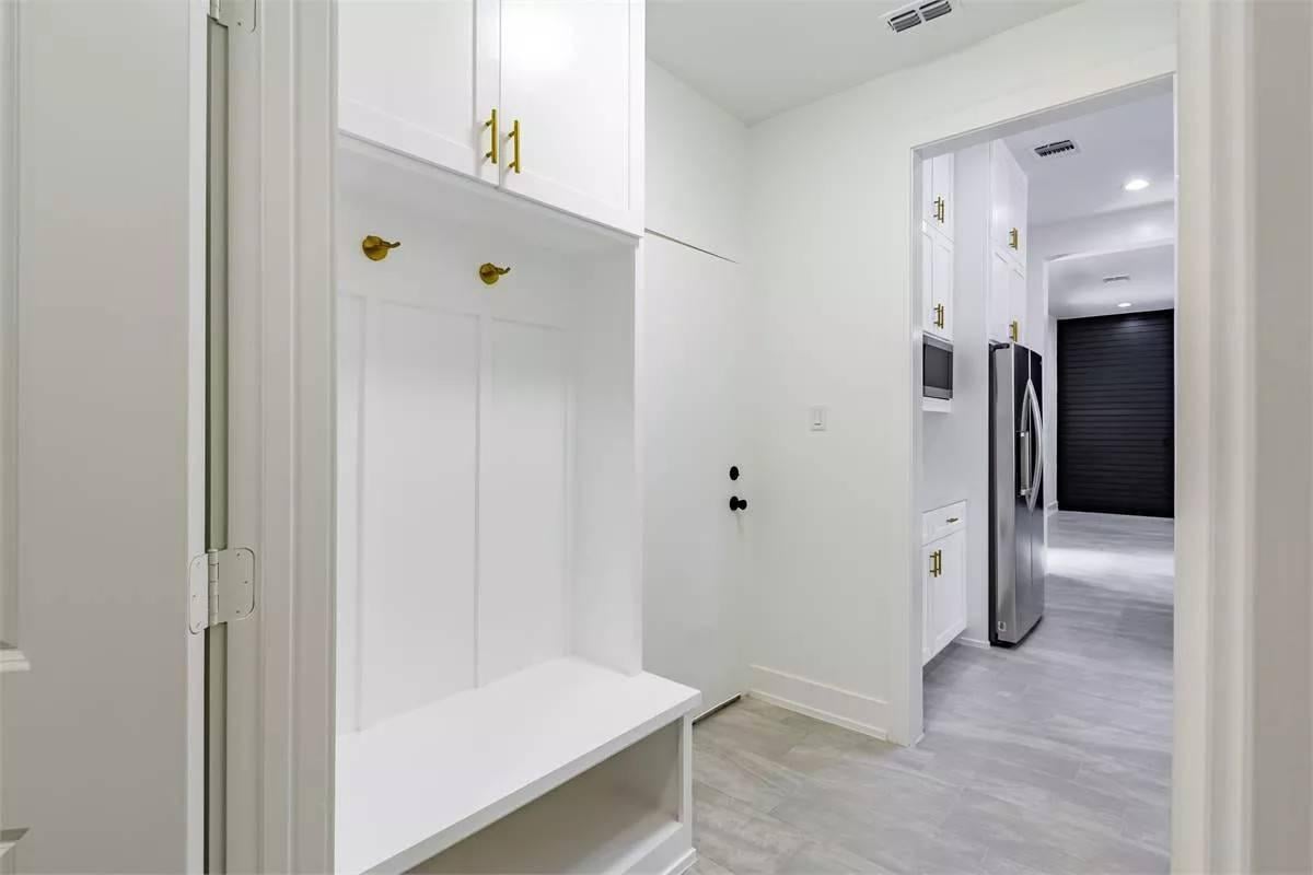 Check Out the Sleek Brass Hooks in This Multi-Functional Mudroom