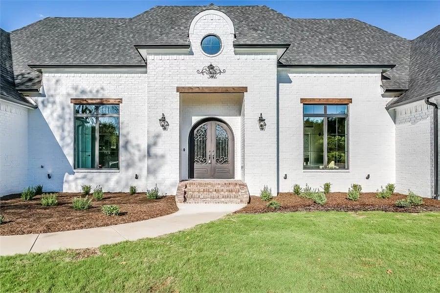 Elegant Entry with Arched Doorway and Charming Round Window