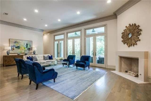 Elegant Living Room with Striking Blue Accent Chairs and Ample Natural Light