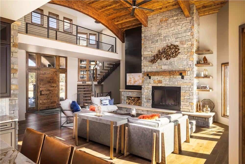 Grand Living Room with Sky-High Stone Fireplace and Open Loft