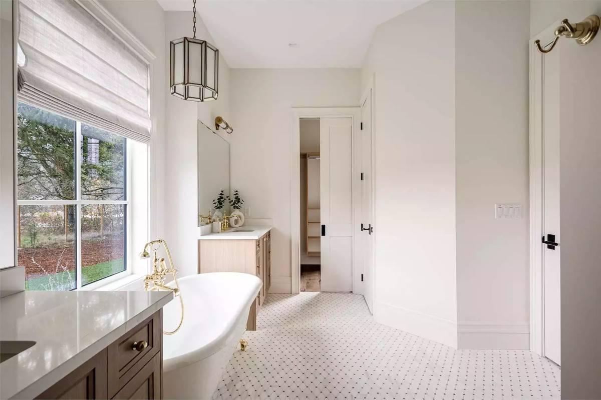 Look at That Freestanding Tub Paired with Elegant Brass Fixtures in This Bathroom