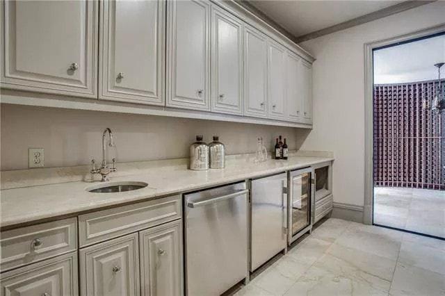 Sleek Utility Room with Wine Cooler and Functional Cabinetry