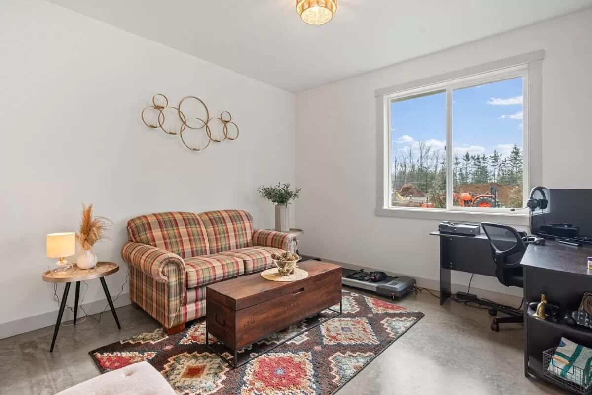 Check Out the Plaid Couch and Eclectic Decor in This Home Office