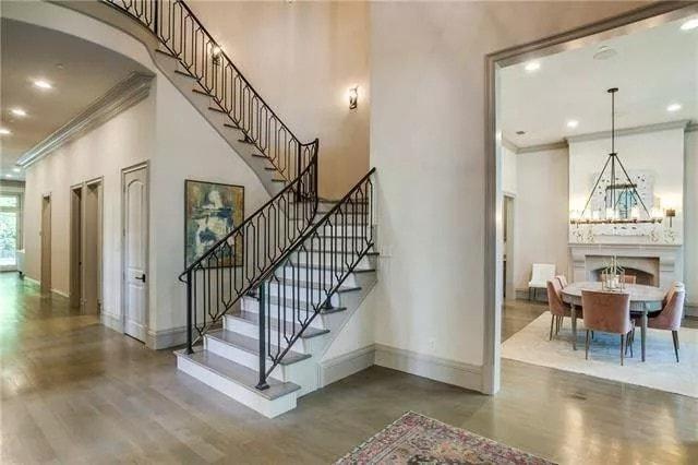 Grand Staircase with Wrought Iron Detailing Leading to a Cozy Dining Area