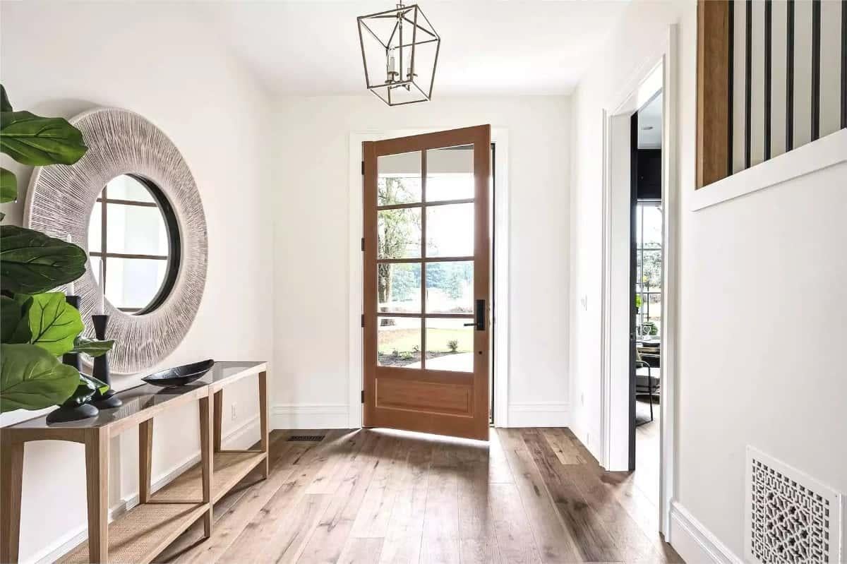 Notice the Striking Circular Mirror in This Elegant Entryway
