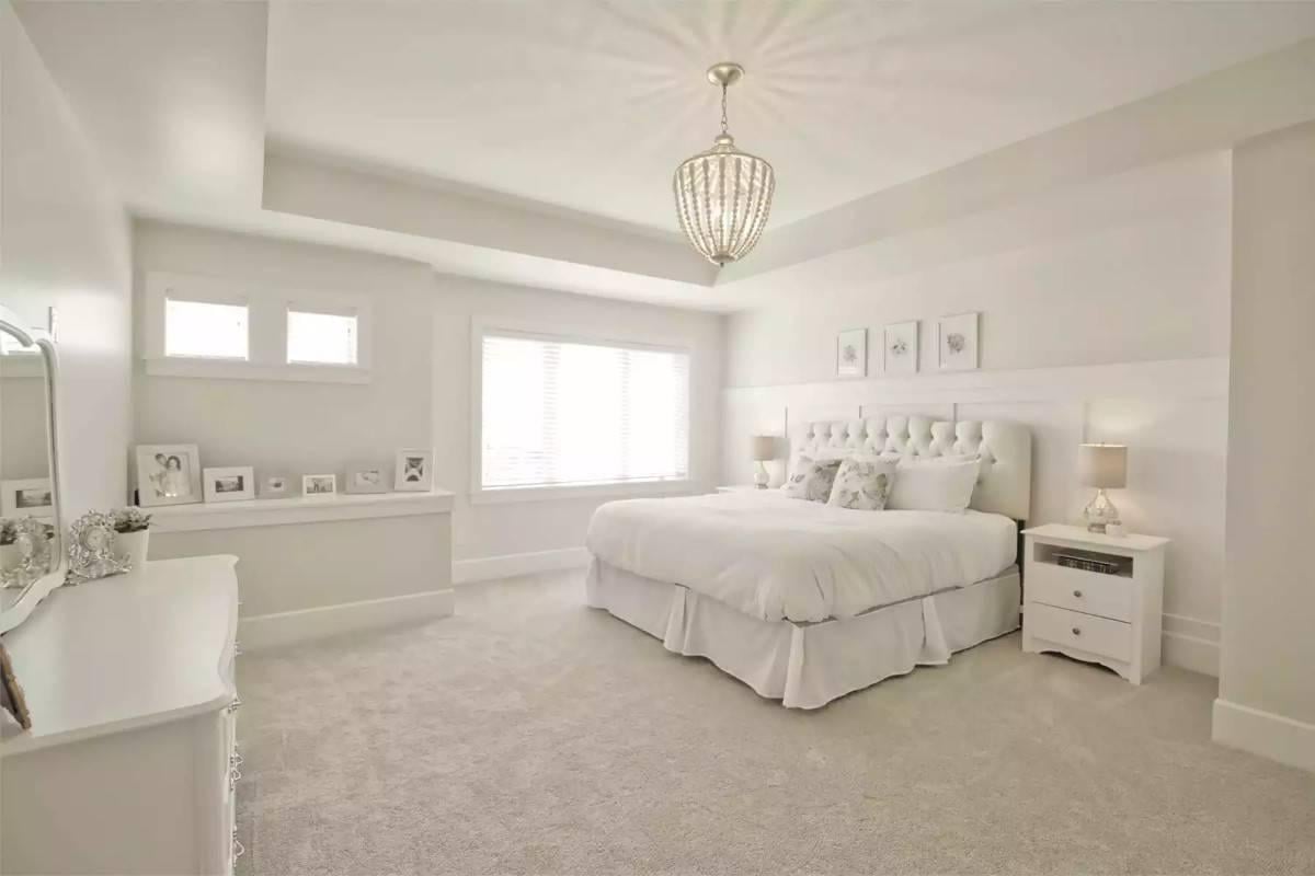 Serene Bedroom with a Unique Tray Ceiling - Lovely Pendant Light