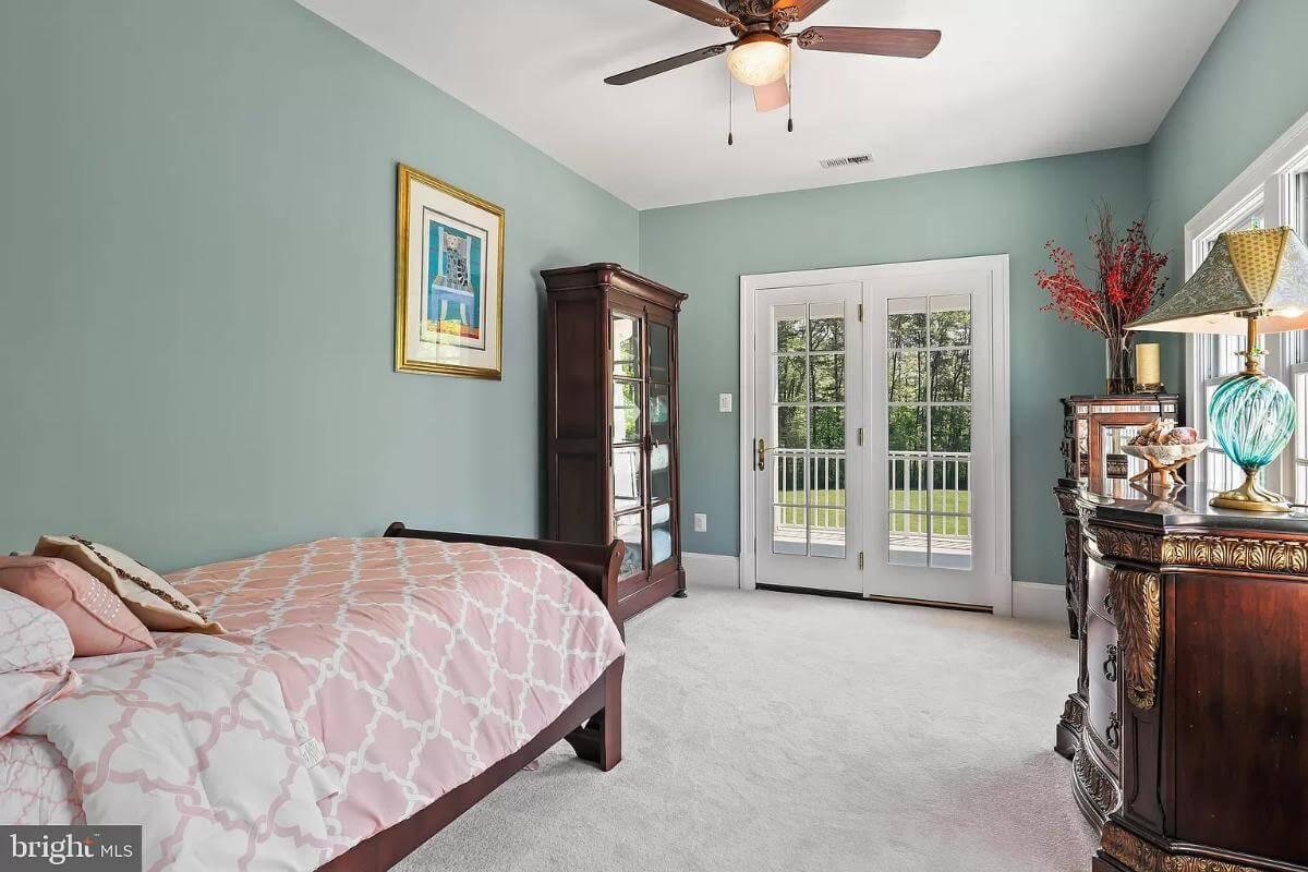 Bright Bedroom with French Doors and Eclectic Decor