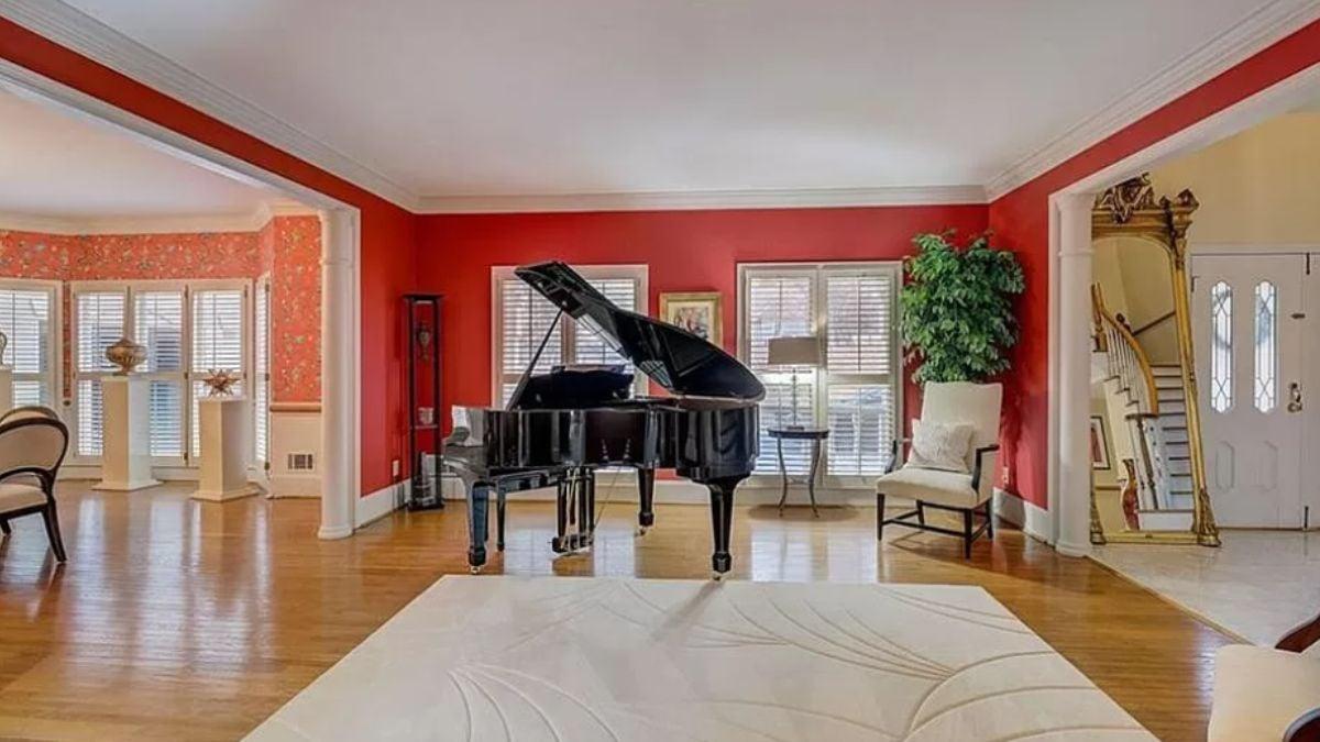 Striking Red Walls Set the Stage for a Grand Piano Showpiece