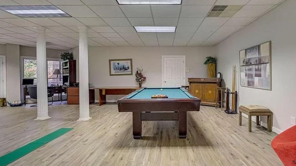 Basement Bonus Room Featuring a Billiards Table and Functional Workspace
