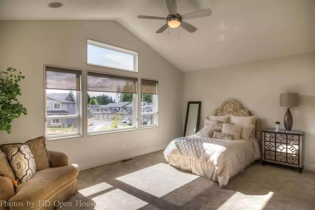 Bright Bedroom with Vaulted Ceiling and Oversized Windows