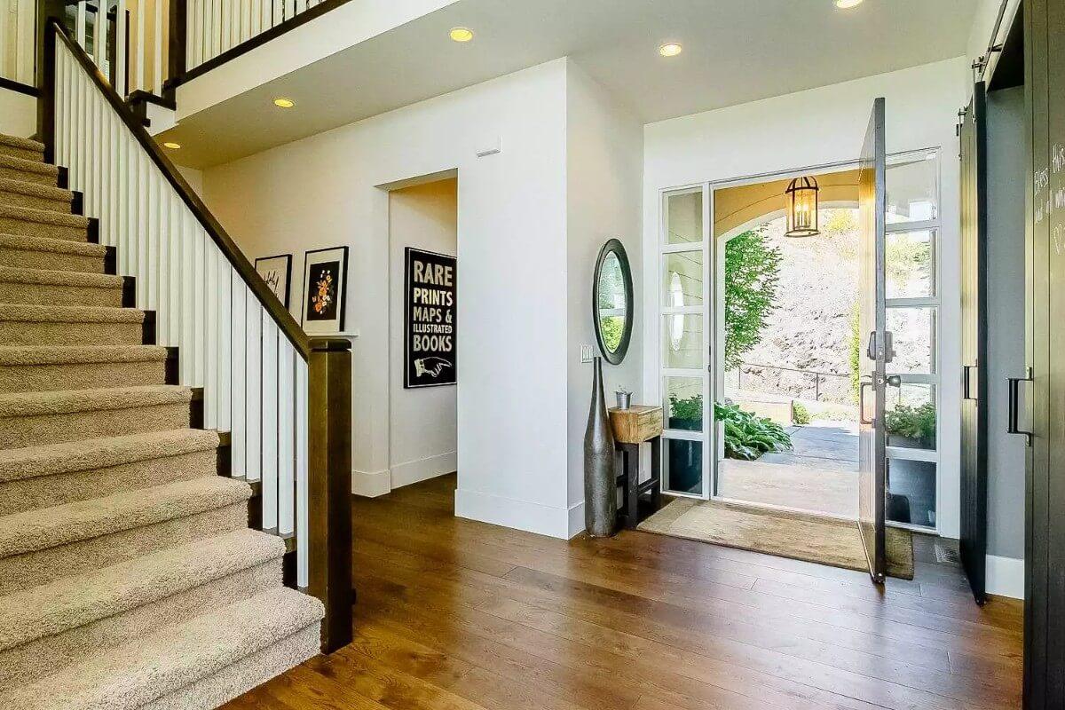 Open and Airy Foyer with Eye-Catching Staircase and Art Nook