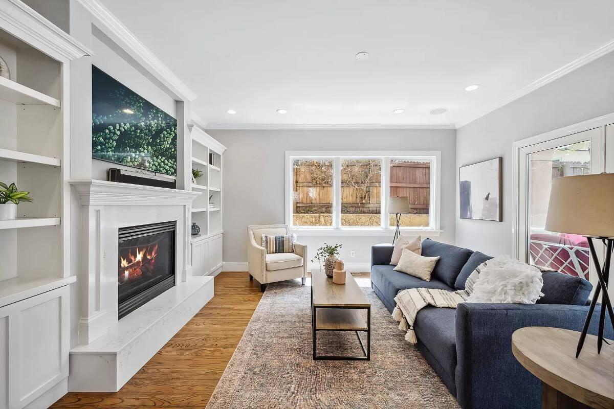 Cozy Living Room Featuring Built-In Shelving and Fireplace