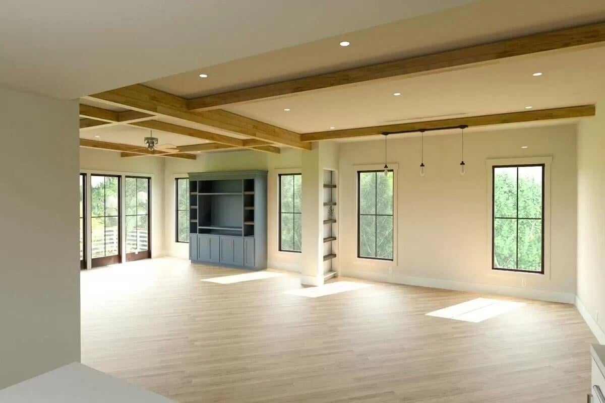 Spacious Living Room with Exposed Wood Beams and Built-in Shelving