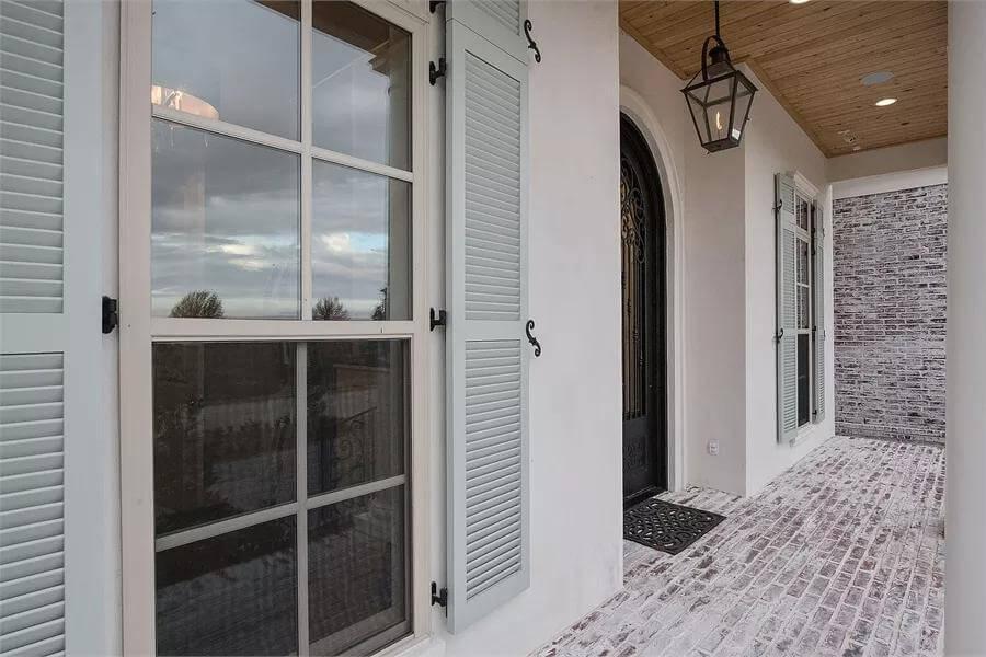 Notice the Charming Shutters and Classic Brick Walkway