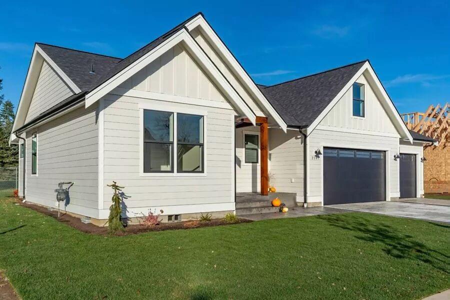 Craftsman Home with Sleek Black Garage Doors and Crisp White Siding