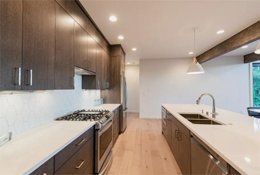 Sleek Kitchen with Hexagonal Backsplash and Expansive Island