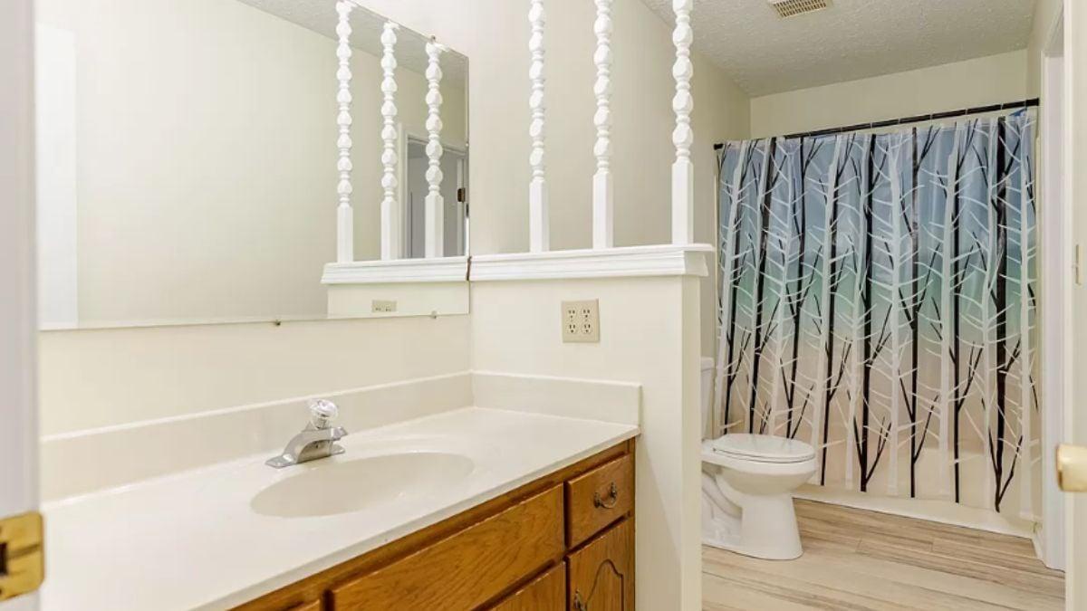 Unique Bathroom with Decorative Spindles and Earthy Shower Curtain