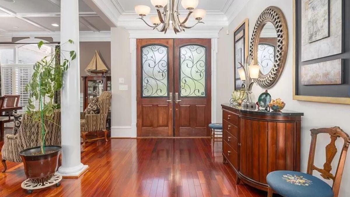 Elegant Entryway Showcasing Ornate Glass Doors and Rich Wood Flooring