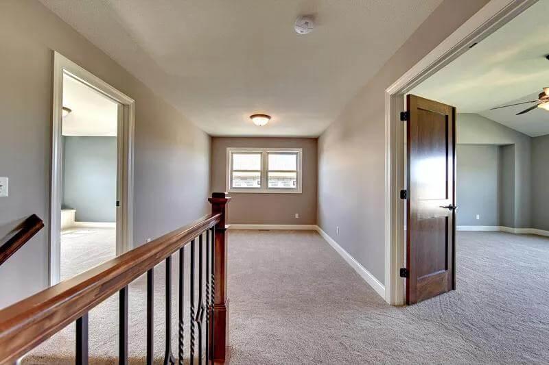 Explore the Carpeted Upper Landing with Elegant Railings