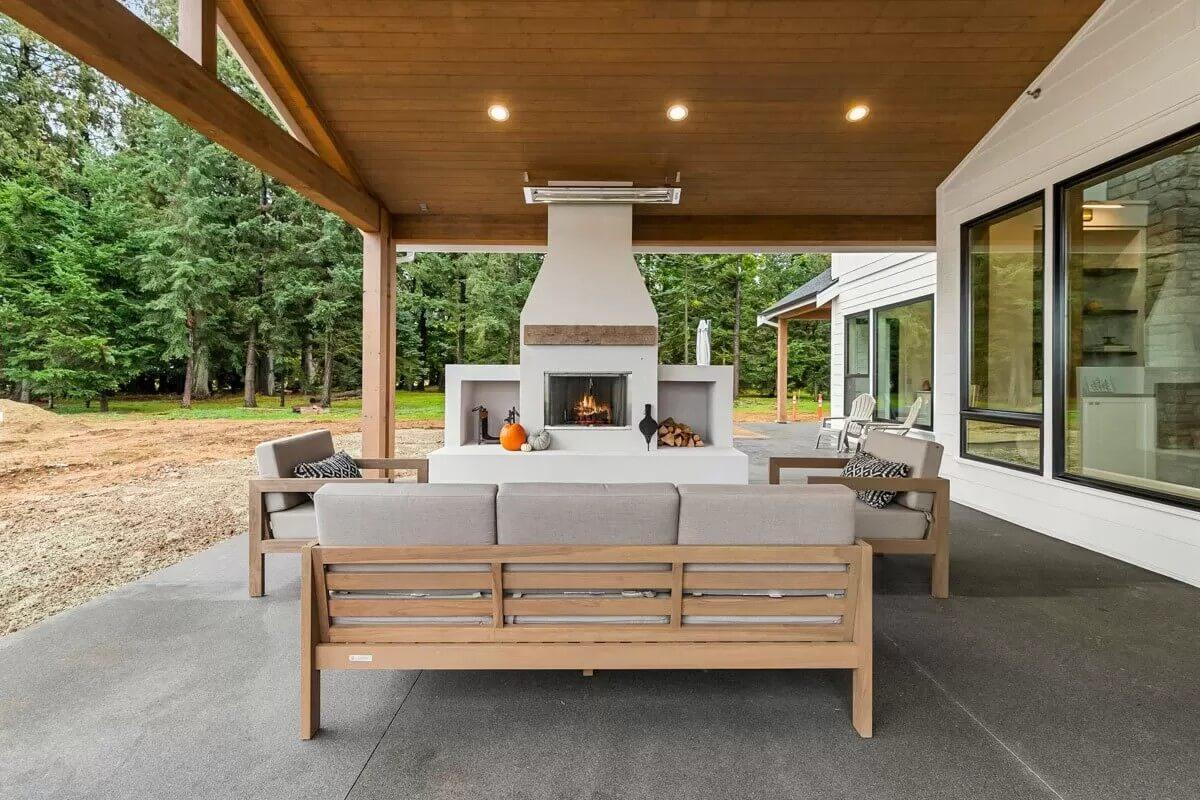 Enjoy the Outdoor Living Room with Its Inviting Fireplace