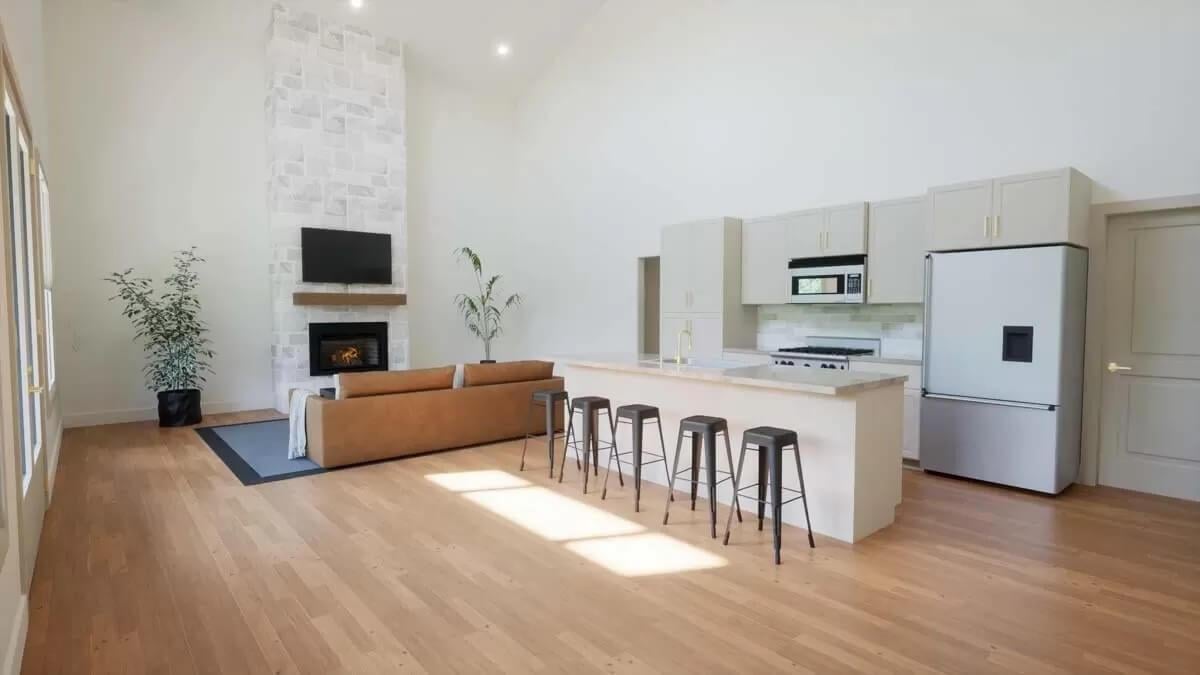 Expansive Living Space with Vaulted Ceilings and Stone Fireplace