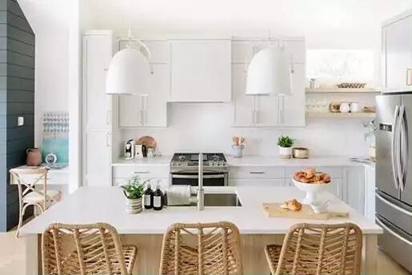 Wicker Barstools Steal the Show in This Crisp White Kitchen