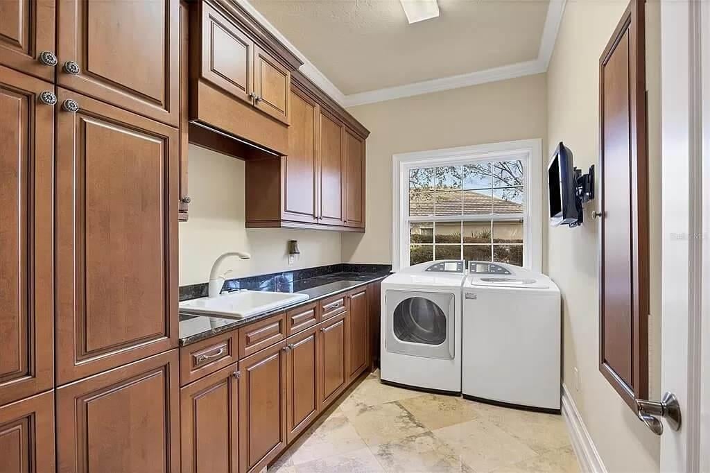 Stylish Laundry Room with Rich Wood Cabinets and Practicality