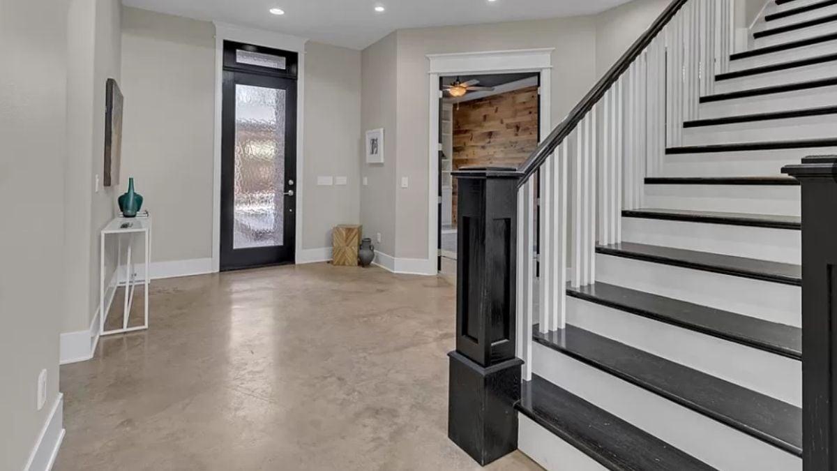 Check Out This Entryway With a Striking Black and White Staircase
