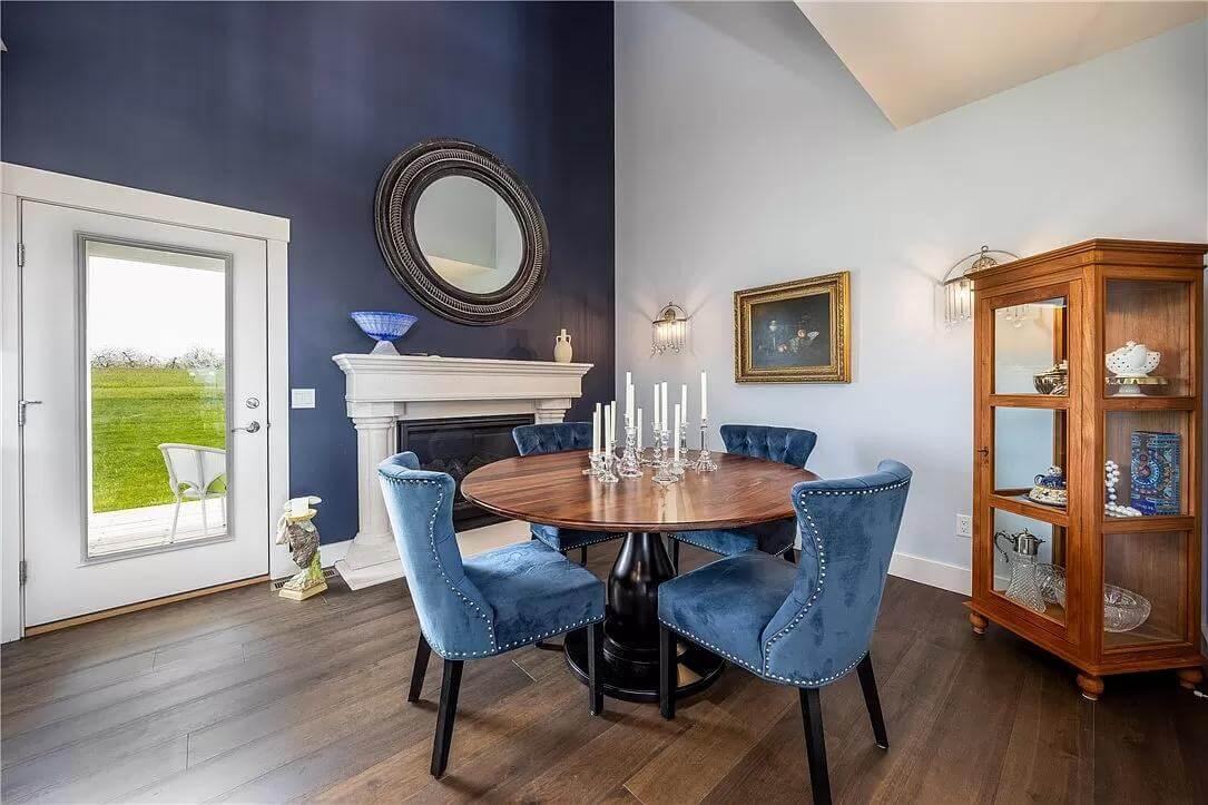 Admire the Bold Use of Blue Velvet Chairs in This Dining Space