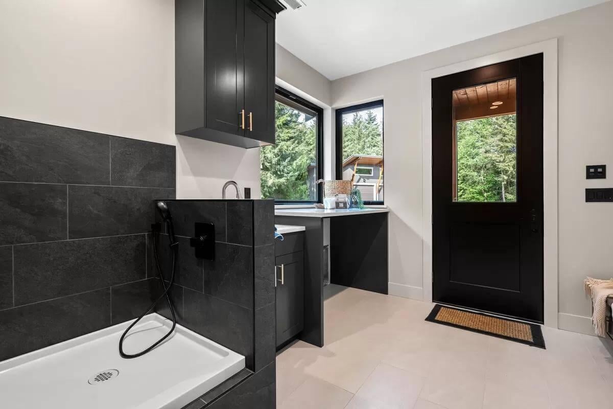 Explore the Modern Charm of This Dark-Tiled Pet Wash Station