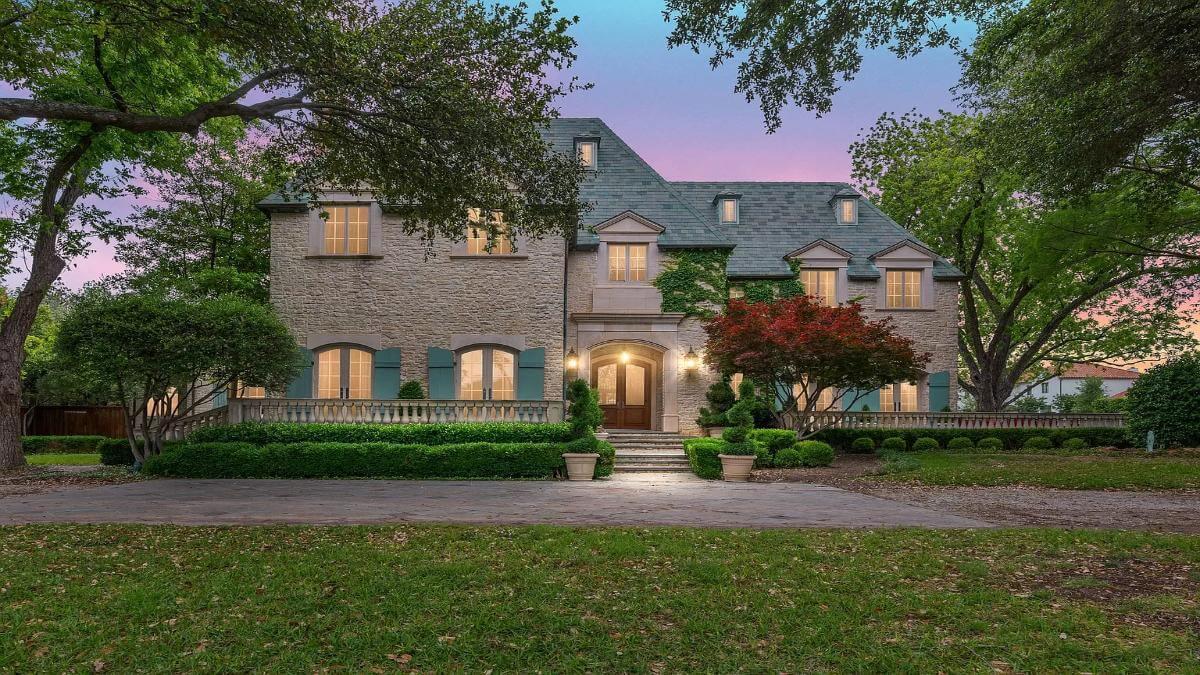 This Stone-clad Home Invokes a French Chateau Feel, Complete with Shuttered Windows