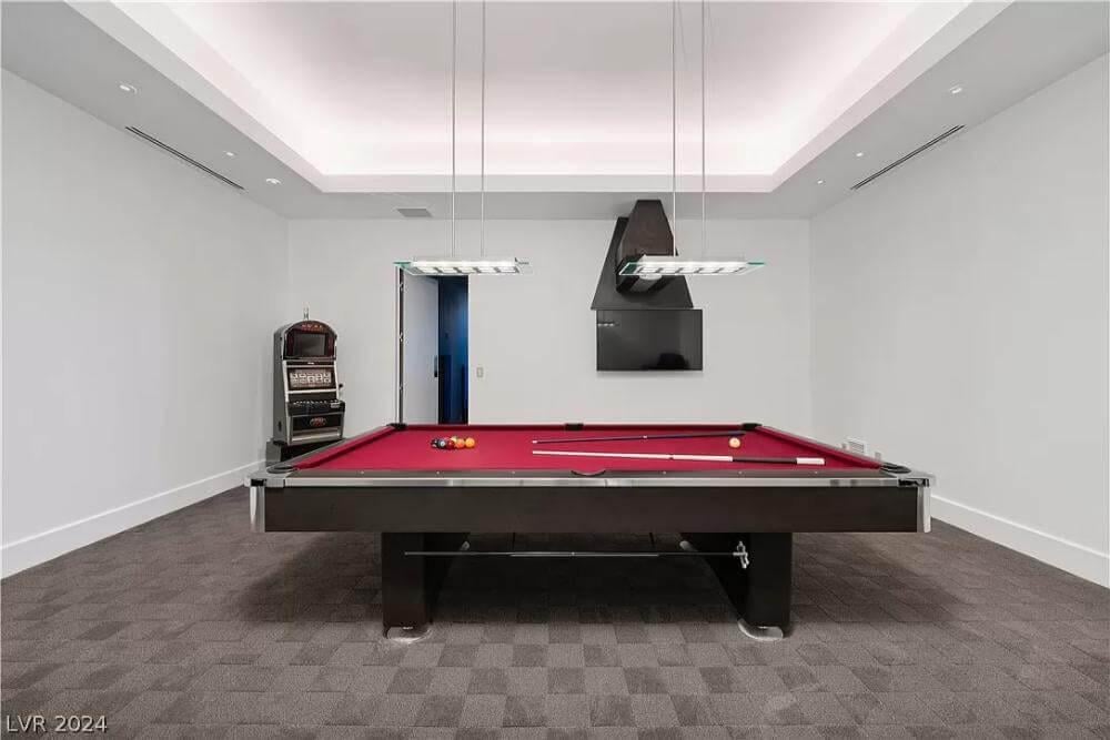 Sleek Game Room with a Stylish Red Pool Table