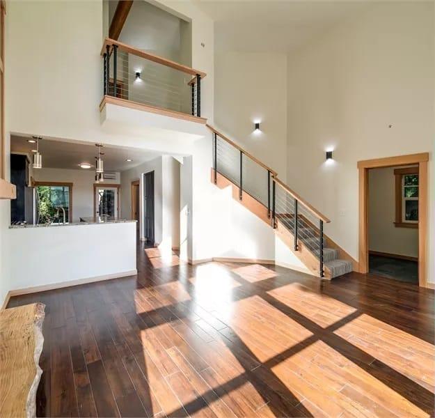 Wow, Check Out the High Ceilings and Floating Staircase in This Sunlit Space
