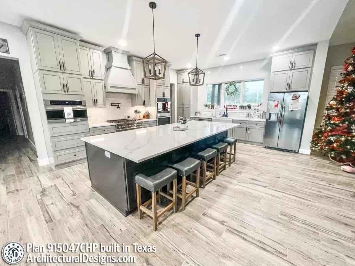 Check Out the Sleek Island and Modern Lighting in This Festive Kitchen