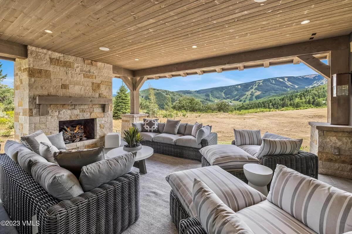 Relax by the Stone Fireplace in This Mountain-View Patio