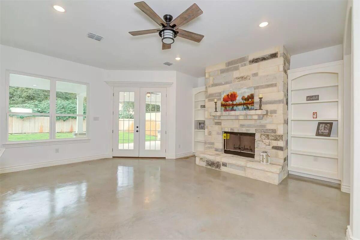 Check Out the Sleek Fireplace with Built-In Shelving Adjacent