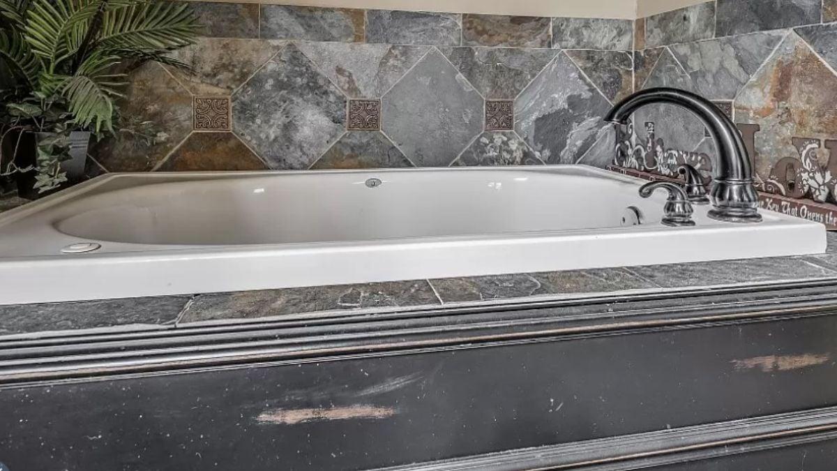 Notice the Elegant Slate Tile Surrounding This Soaking Tub